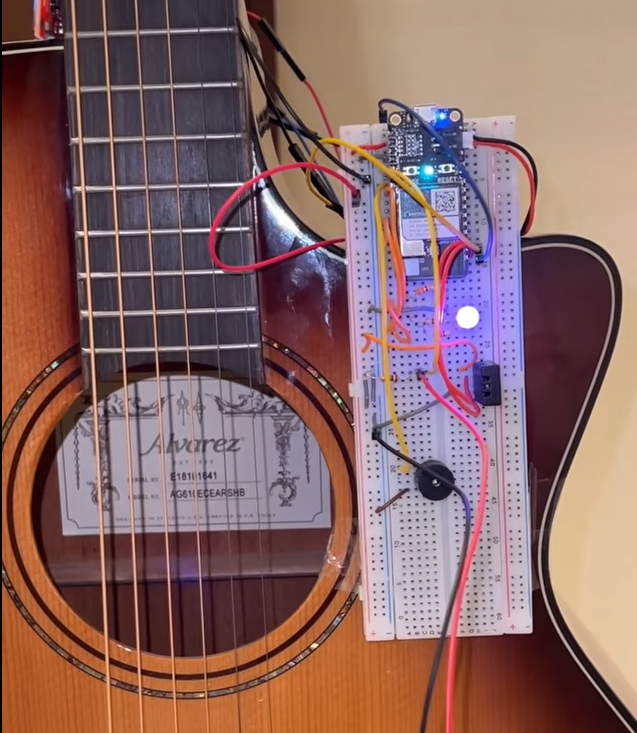 Fion's guitar tuner and metronome circuit mounted on an acoustic guitar