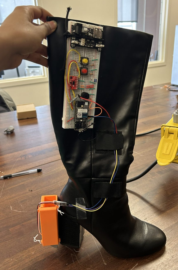 Malithi's black high-heel boot protection prototype with mounted electronics